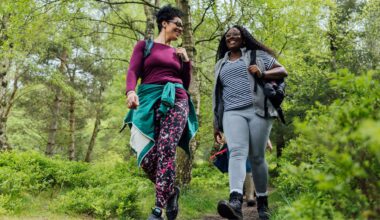 woman walking through a wooded area on a hike