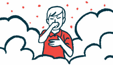 A person puts one hand to their chest and covers their mouth with the other while standing amid a cloud of air pollution.