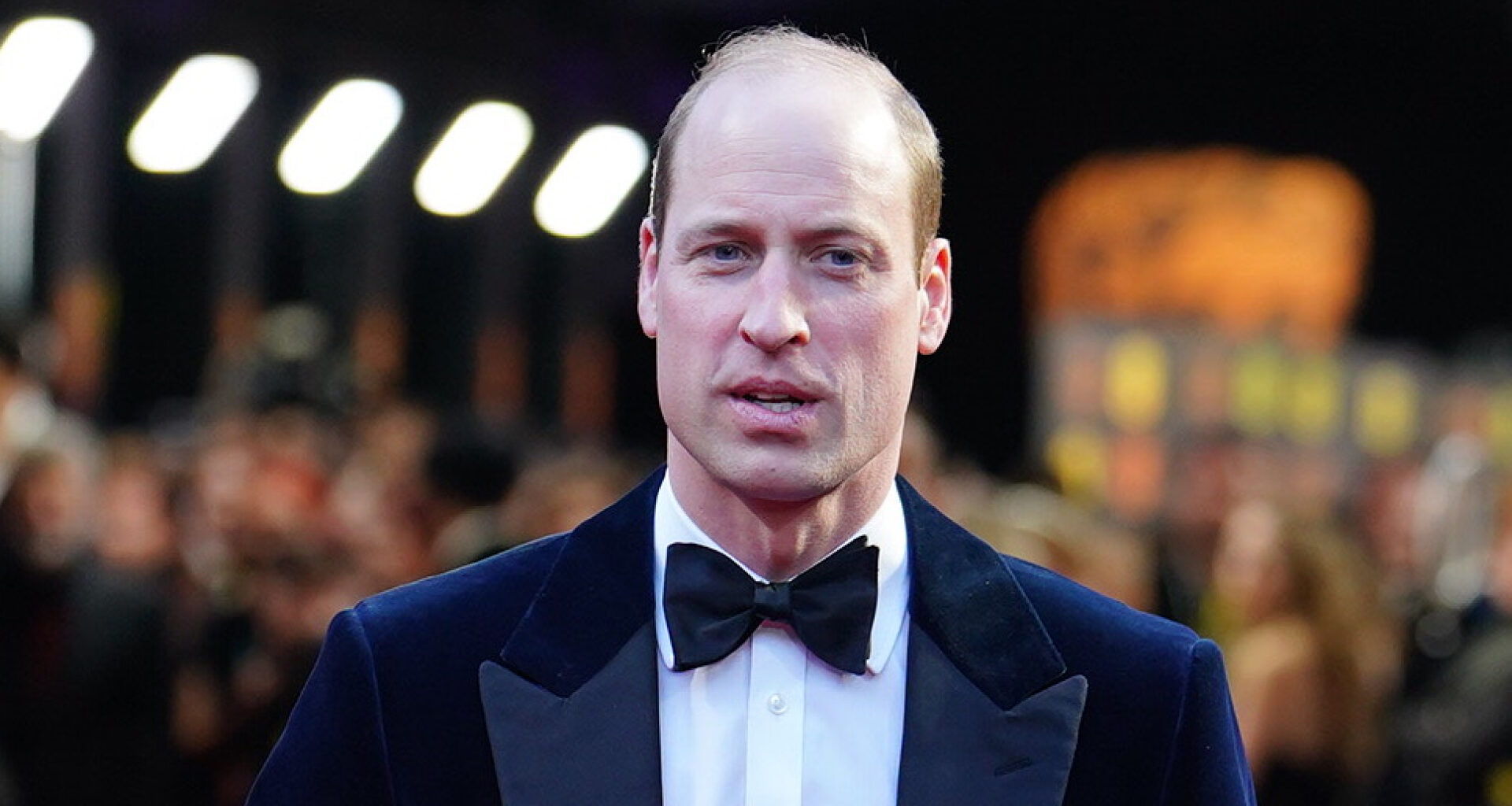 Prince William wears a tuxedo and bow tie on the red carpet