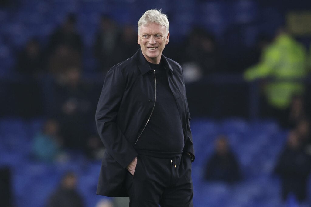 Everton manager David Moyes smiling as his side warms up for a Premier League match.