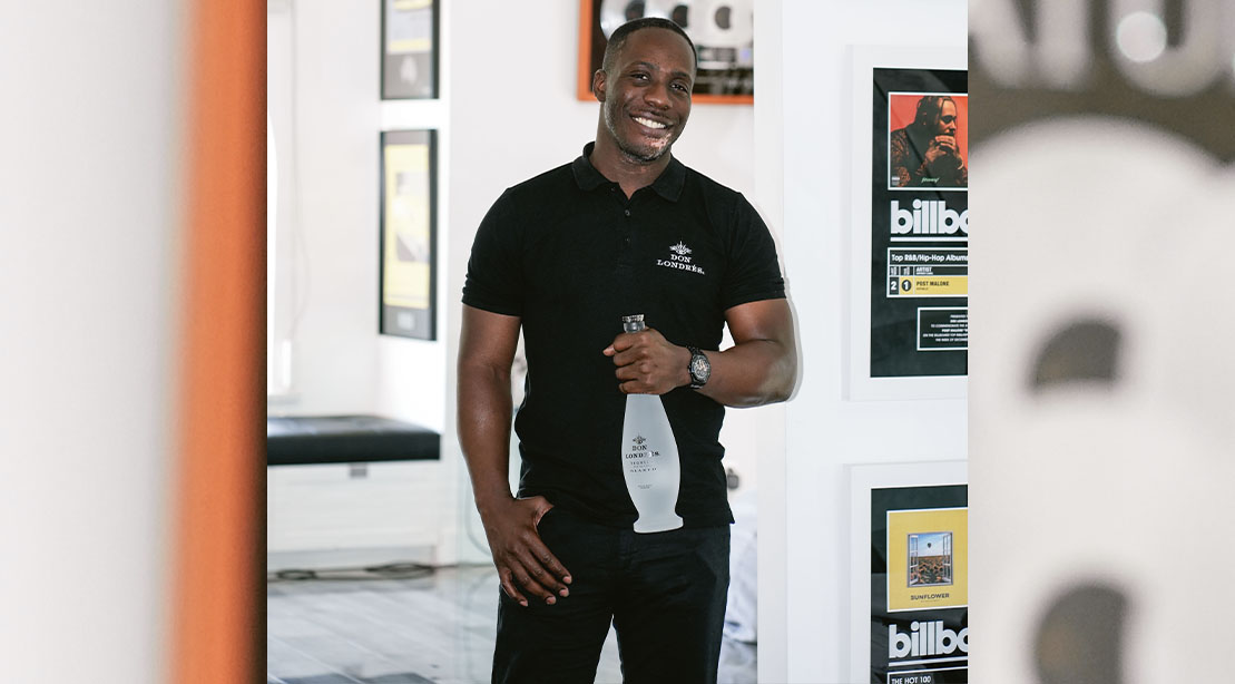 Dre London holding a bottle