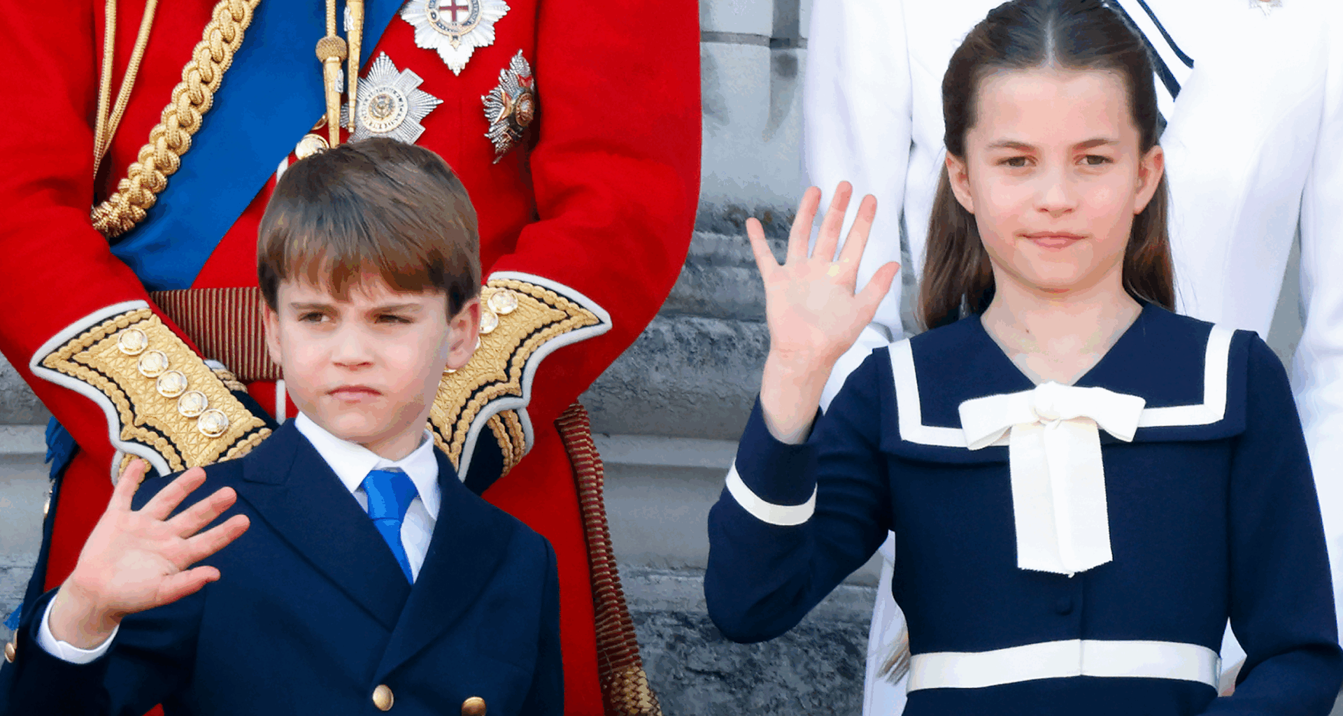 Prince Louis and Princess Charlotte wearing navy outfits and waving on Buckingham Palace's balcony