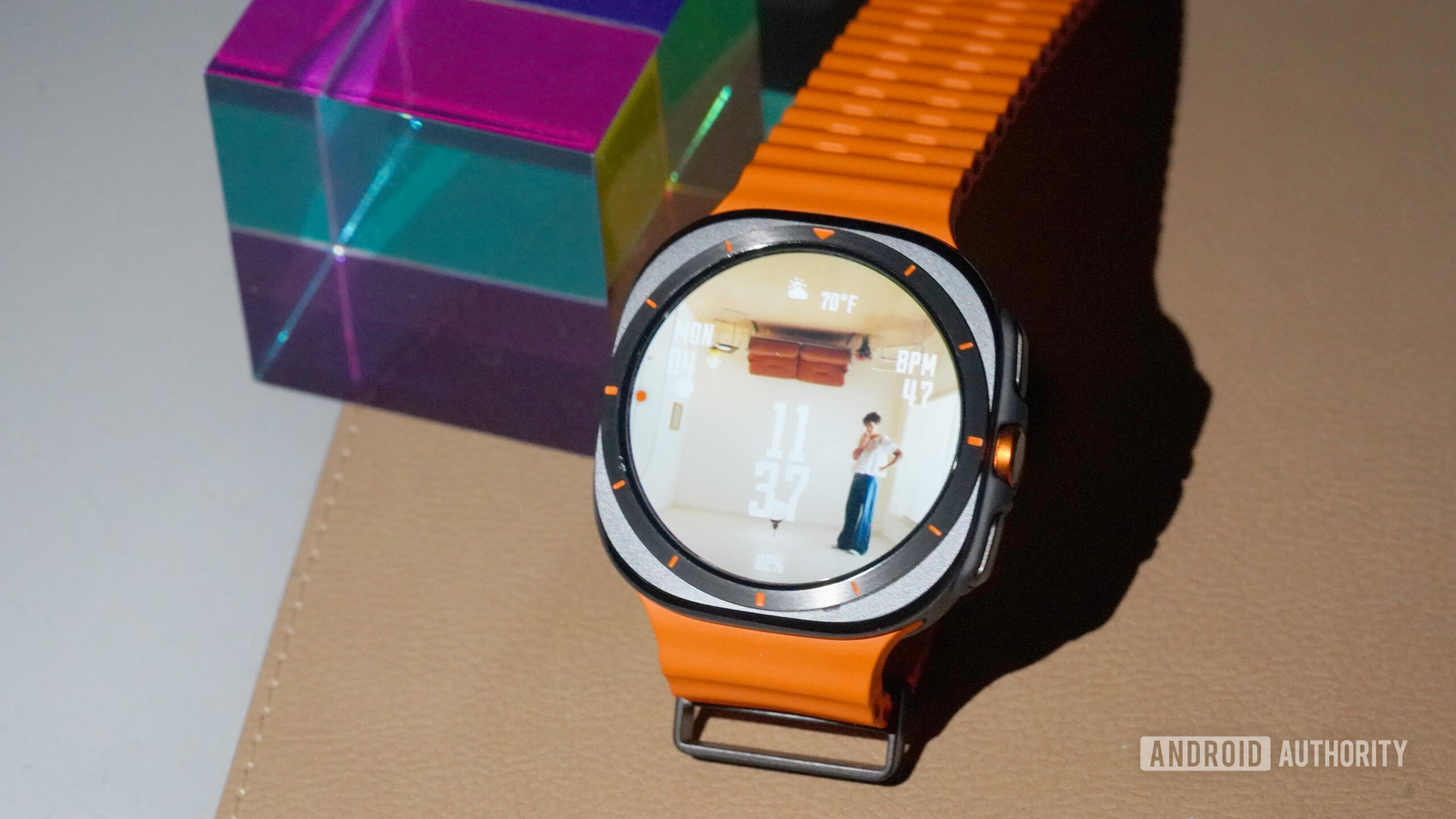 A Galaxy Watch Ultra displays a Harry Styles watch face.