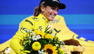 Pauline Ferrand-Prévot on the podium wearing the yellow jersey at the Tour de France Femmes 2025
