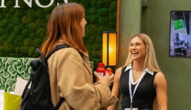 Two women in conversation and laughing at the Independent Hotel Show 2025
