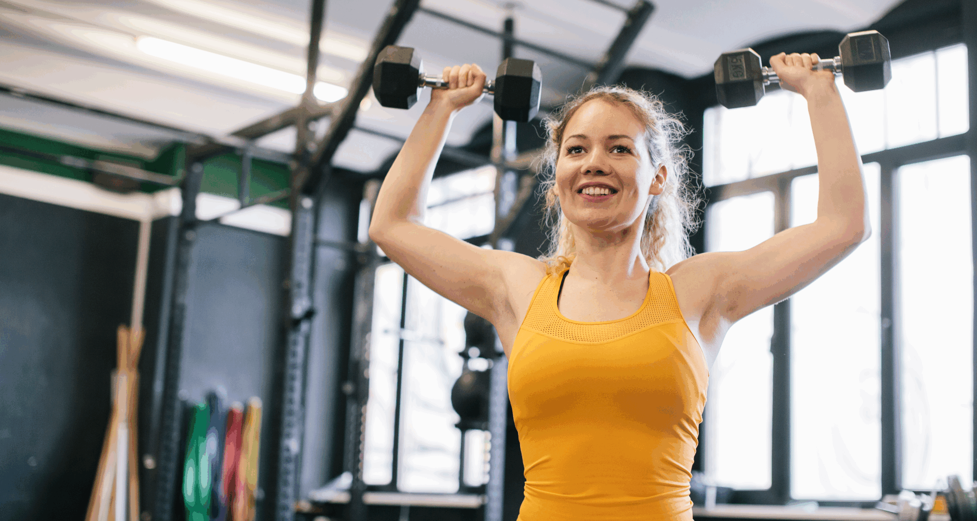 A woman doing dumbbell shoulder press