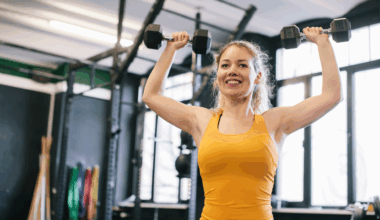 A woman doing dumbbell shoulder press