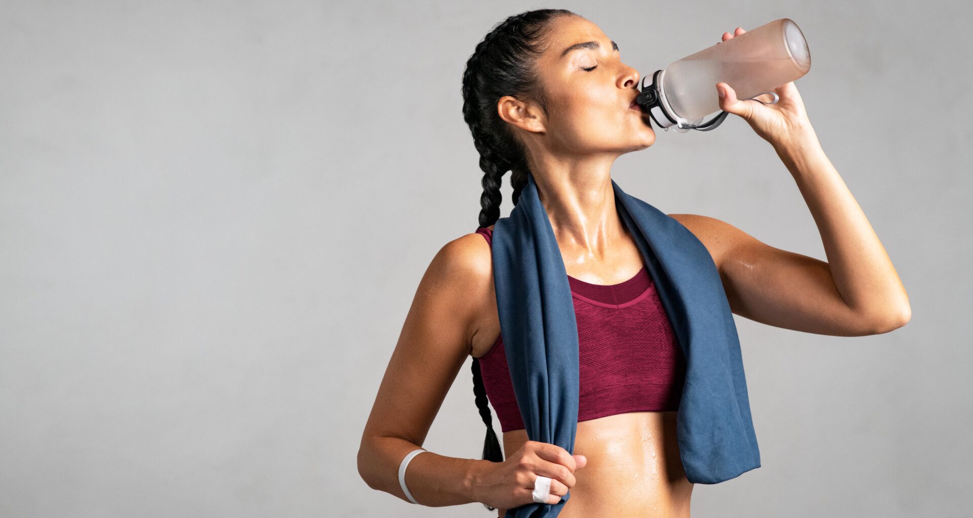 woman drinking water post-workout