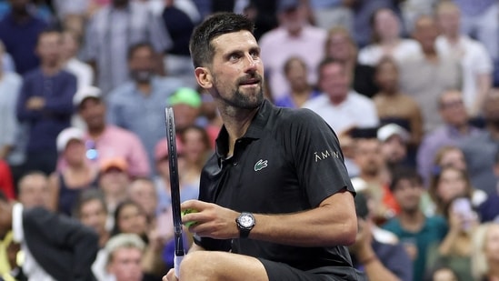 NEW YORK, NEW YORK - AUGUST 24: Novak Djokovic of Serbia hits balls into the crowd after defeating Learner Tien of the United States during their Men's Singles First Round match on Day One of the 2025 US Open at USTA Billie Jean King National Tennis Center on August 24, 2025 in the Flushing neighborhood of the Queens borough of New York City. (Getty Images via AFP)