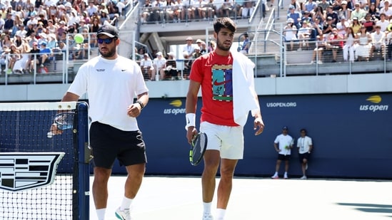 Carlos Alcaraz of Spain with his brother Alvaro Alcaraz as he walks to takes a break during a practice session ahead of the US Open(Getty Images via AFP)