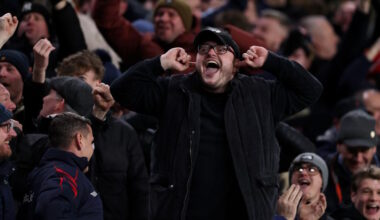 Football fans taunt rivals supporters during a game