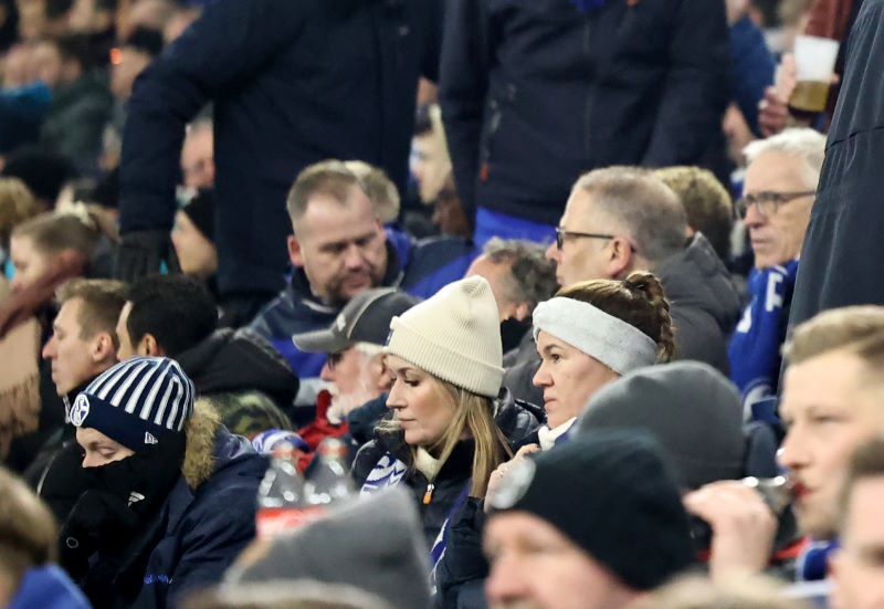 Fans watch on from the stands, wrapped up warm due to the cold weather