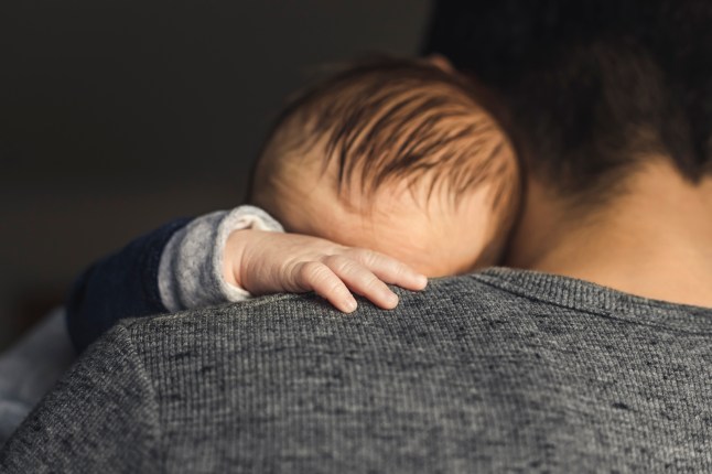 Baby boy on dad's arms