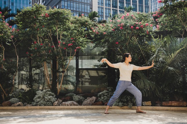 asian businesswoman practicing tai chi in the city