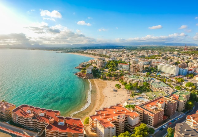 An aerial view of a beach, hotels and cityscape in Salou, Costa Dorada in Spain, on a bright sunny day.