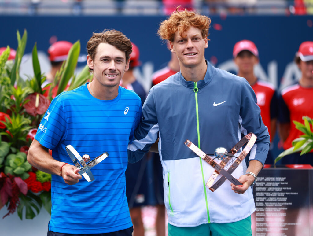 Jannik Sinner of Italy (R) and Alex De Minaur of Australia pose with their trophies after the Singles Final during Day Seven of the National Bank Open, part of the Hologic ATP Tour, at Sobeys Stadium on August 13, 2023 in Toronto, Canada.