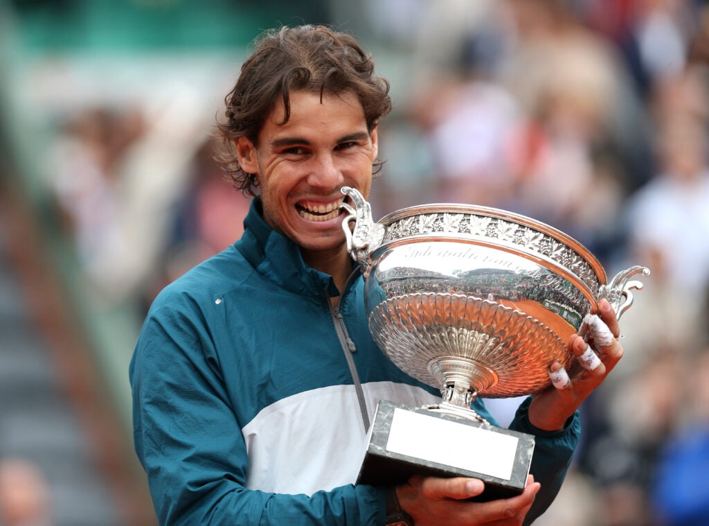 Rafael Nadal bites the trophy after winning the 2013 French Open
