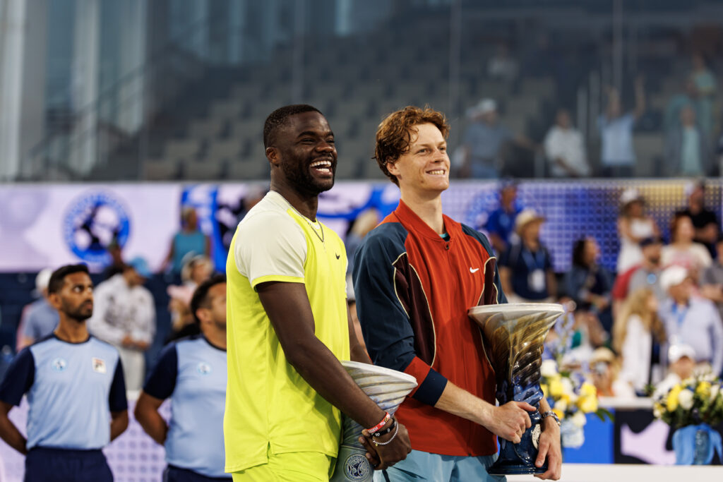 Jannik Sinner and Frances Tiafoe smile with their trophies
