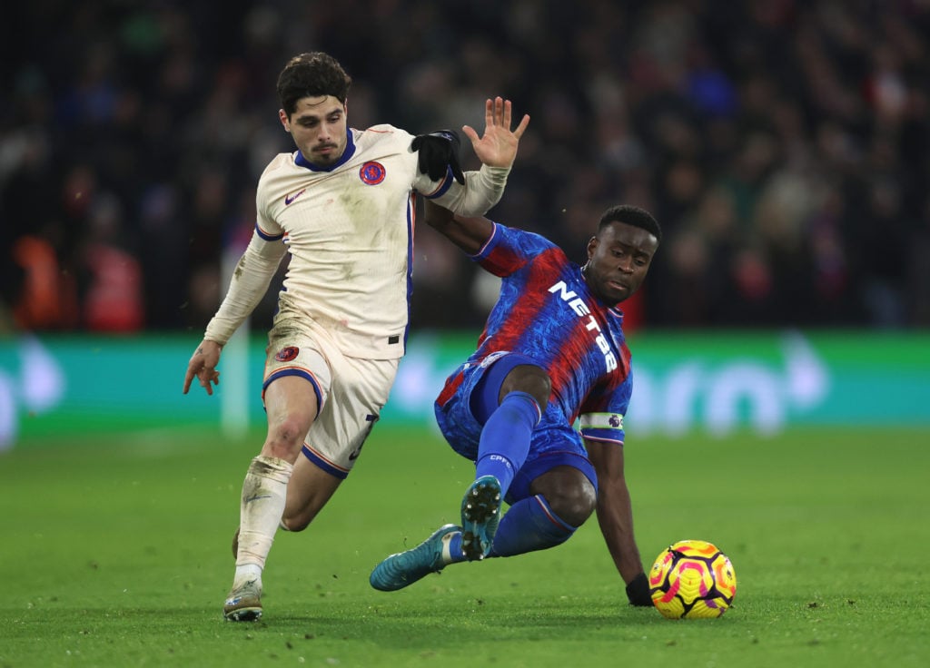 Pedro Neto of Chelsea is challenged by Marc Guehi of Crystal Palace