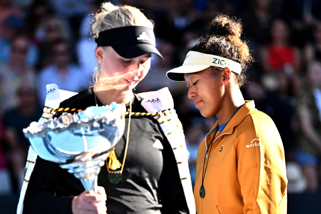 Naomi Osaka walks behind Clara Tauson who is standing with the 2025 ASB Classic trophy