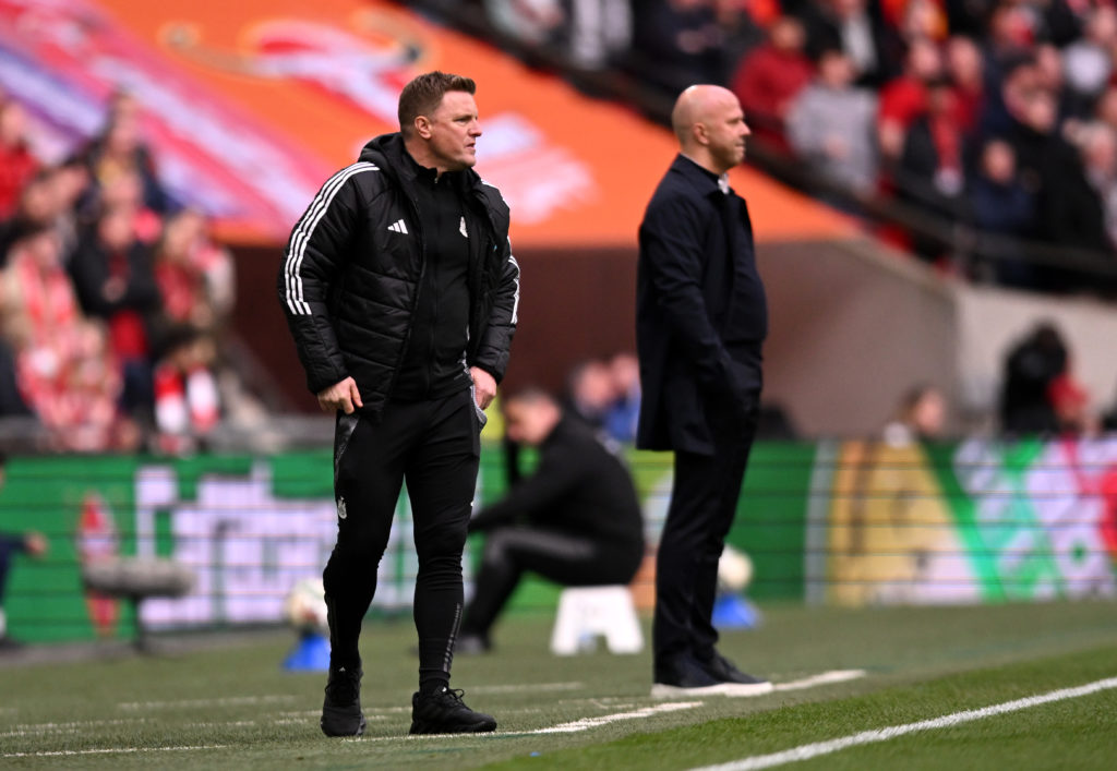 Eddie Howe stands next to Arne Slot on the touchline at Wembley.