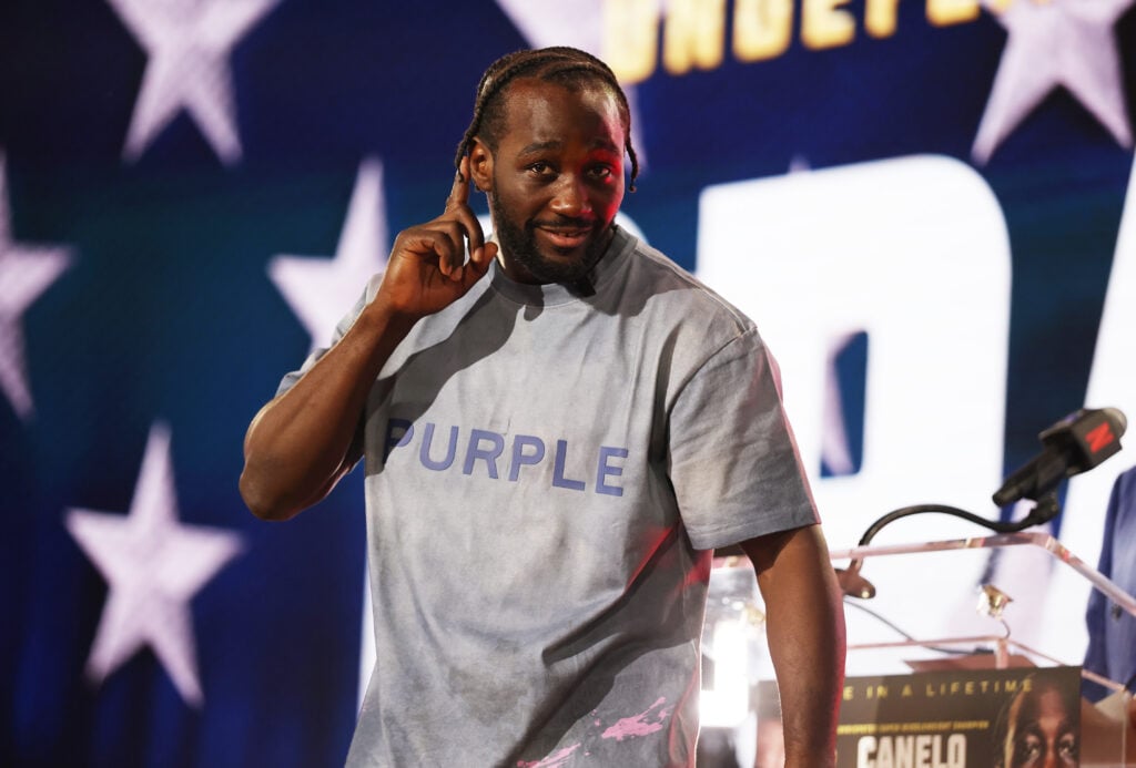 Terence Crawford gestures the crowd at a press conference at Fanatics Fest
