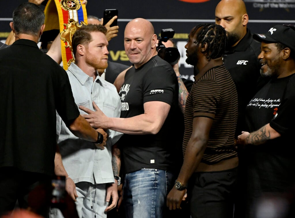 Canelo Álvarez and Terence Crawford are held apart by Dana White at a Press Conference