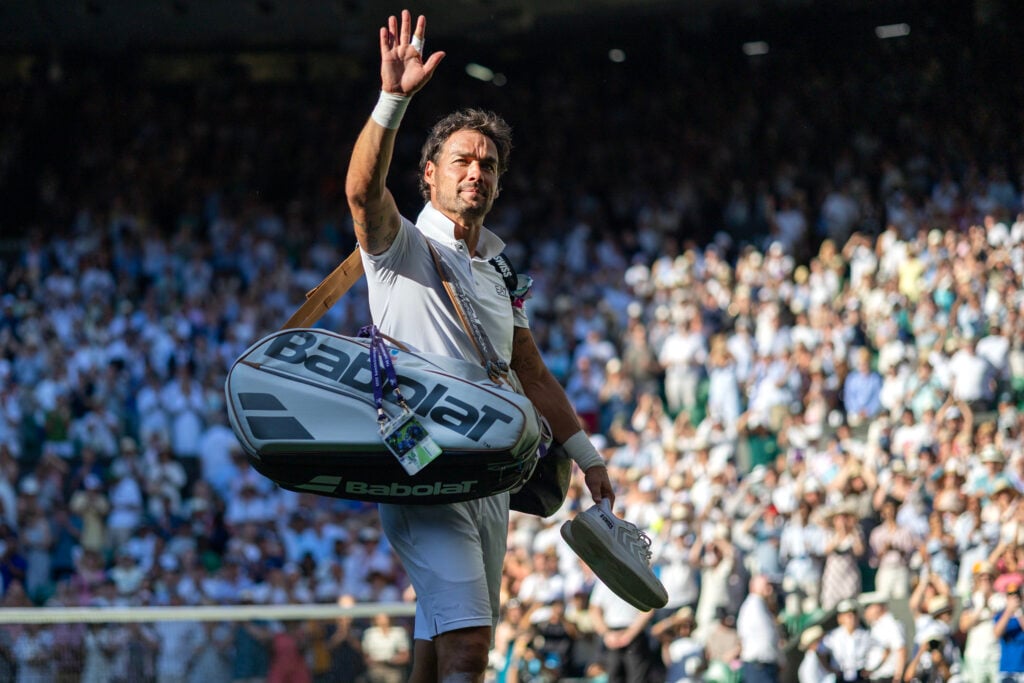 Fabio Fognini of Italy reacts to the applause from the spectators as he leaves the court after his marathon five-set loss against Carlos Alcaraz of Spain in the first round of the Gentlemen's Singles Competition on Centre Court during the Wimbledon Lawn Tennis Championships at the All England Lawn Tennis and Croquet Club.