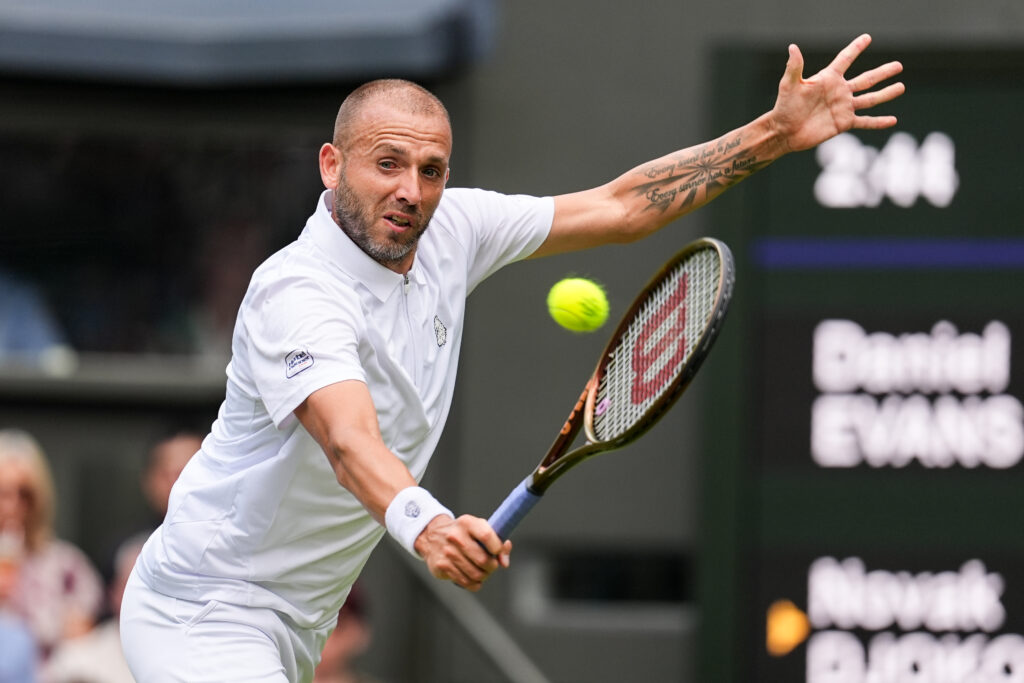 Daniel Evans of United Kingdom plays a backhand in the Men's Singles Second Round match against Novak Djokovic of Serbia on day four of The Championships Wimbledon 2025 at All England Lawn Tennis and Croquet Club on July 03, 2025 in London, England.