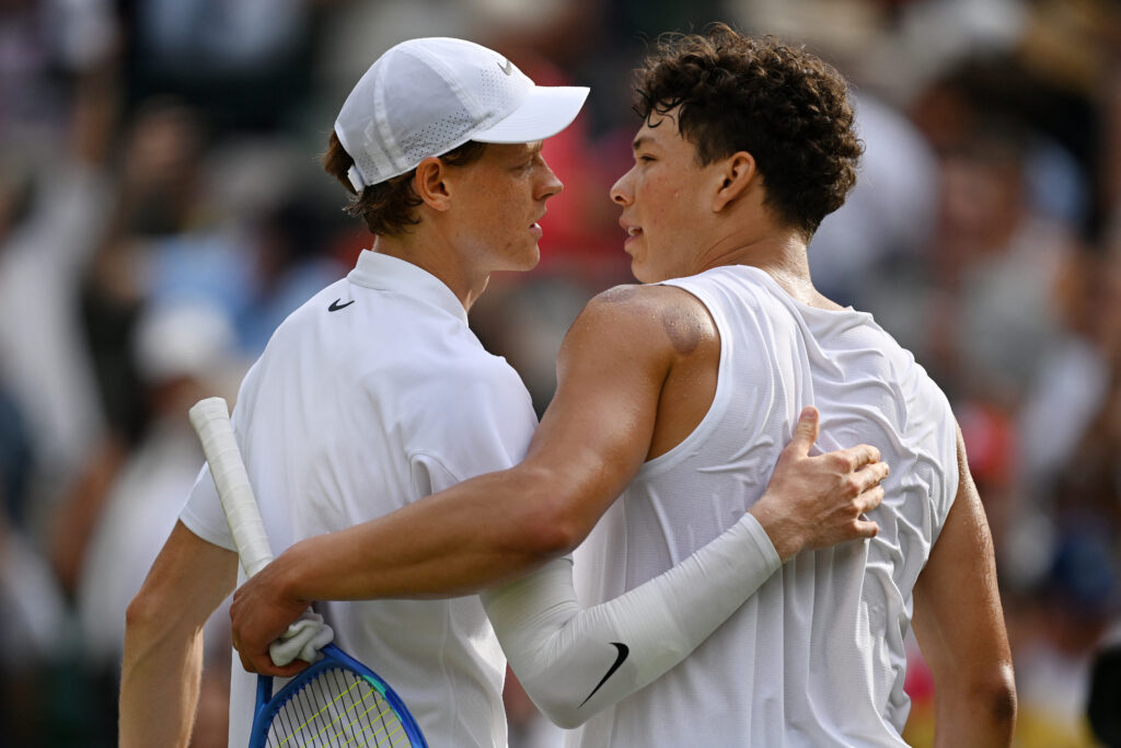 Jannik Sinner of Italy embraces Ben Shelton of United States at the net following the Gentlemen's Singles quarter-final match on day ten of The Championships Wimbledon 2025 at All England Lawn Tennis and Croquet Club on July 09, 2025 in London, England.
