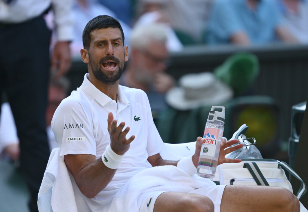 Novak Djokovic of Serbia reacts in a change over against Jannik Sinner of Italy during the Gentlemen's Singles semi-final match on day twelve of The Championships Wimbledon 2025 at All England Lawn Tennis and Croquet Club on July 11, 2025 in London, England.