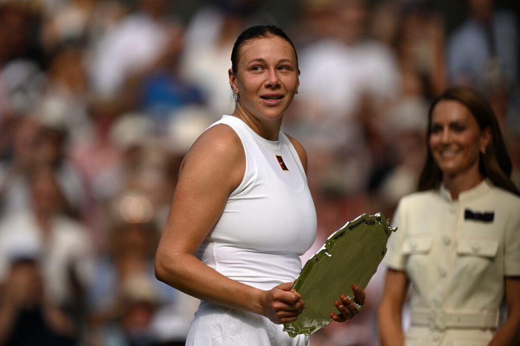 Amanda Anisimova of United States leaves the court with the Ladies’ Singles runner up Trophy following defeat against Iga Swiatek of Poland in the Ladies' Singles Final on day thirteen of The Championships Wimbledon 2025 at All England Lawn Tennis and Croquet Club.