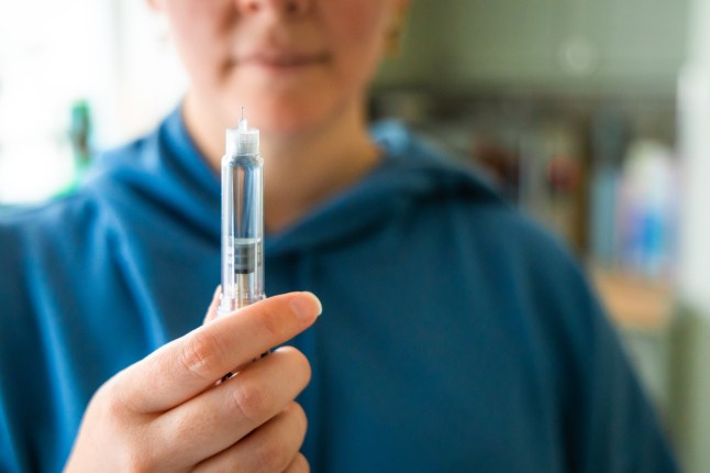 Woman preparing to administer weight loss injection