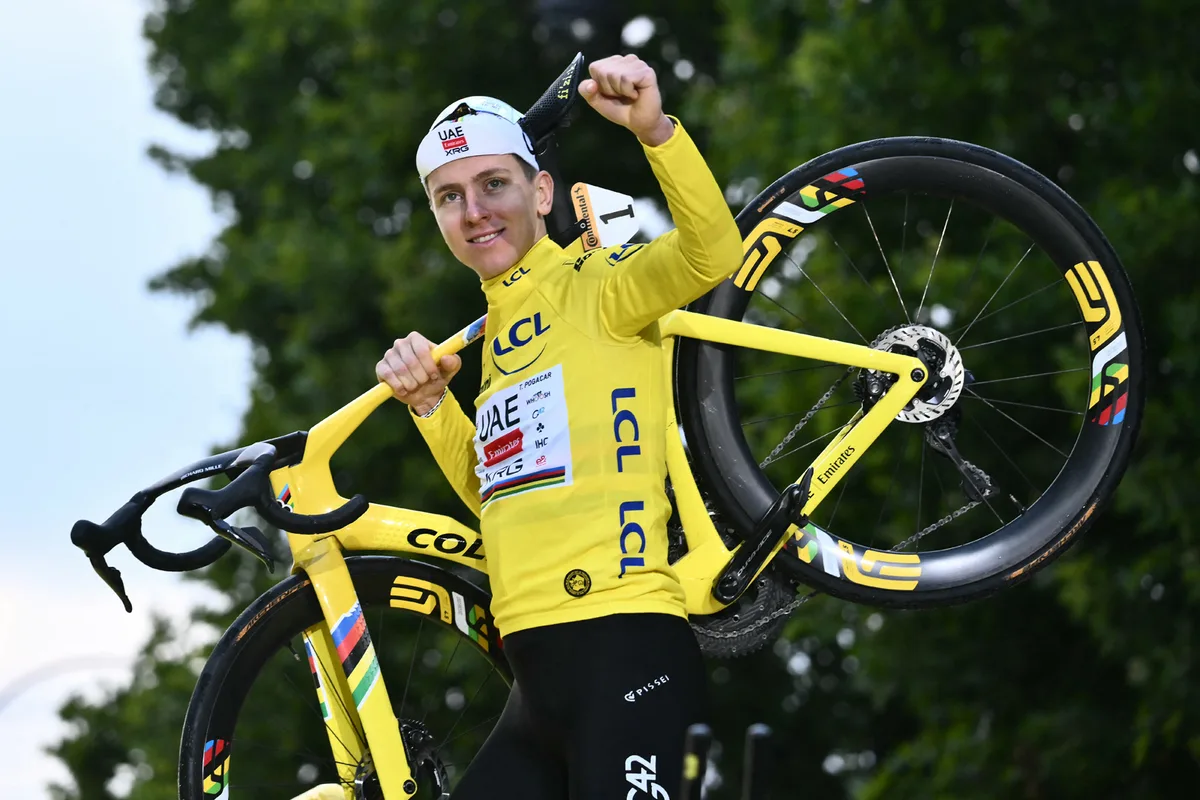 Tadej Pogacar celebrates on the podium with the overall leader's yellow jersey after the 21st and final stage of the 112th edition of the Tour de France cycling race.
