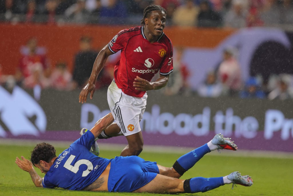 Patrick Dorgu playing for Manchester United in pre-season, with Bournemouth player on the floor