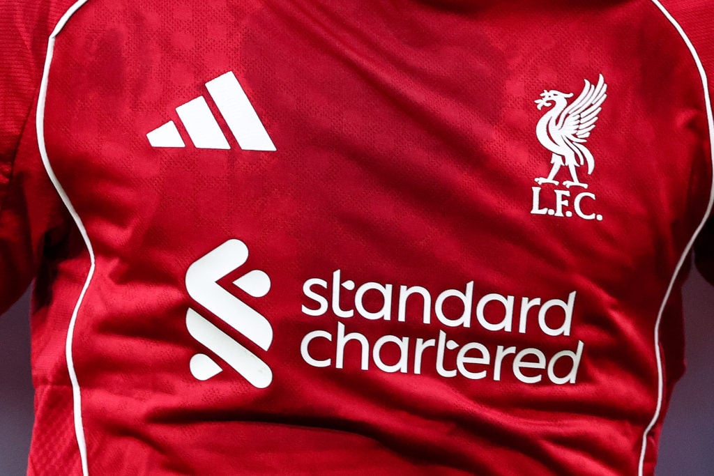 A closeup shot of the Liverpool home shirt with Adidas and Standard Chartered logos