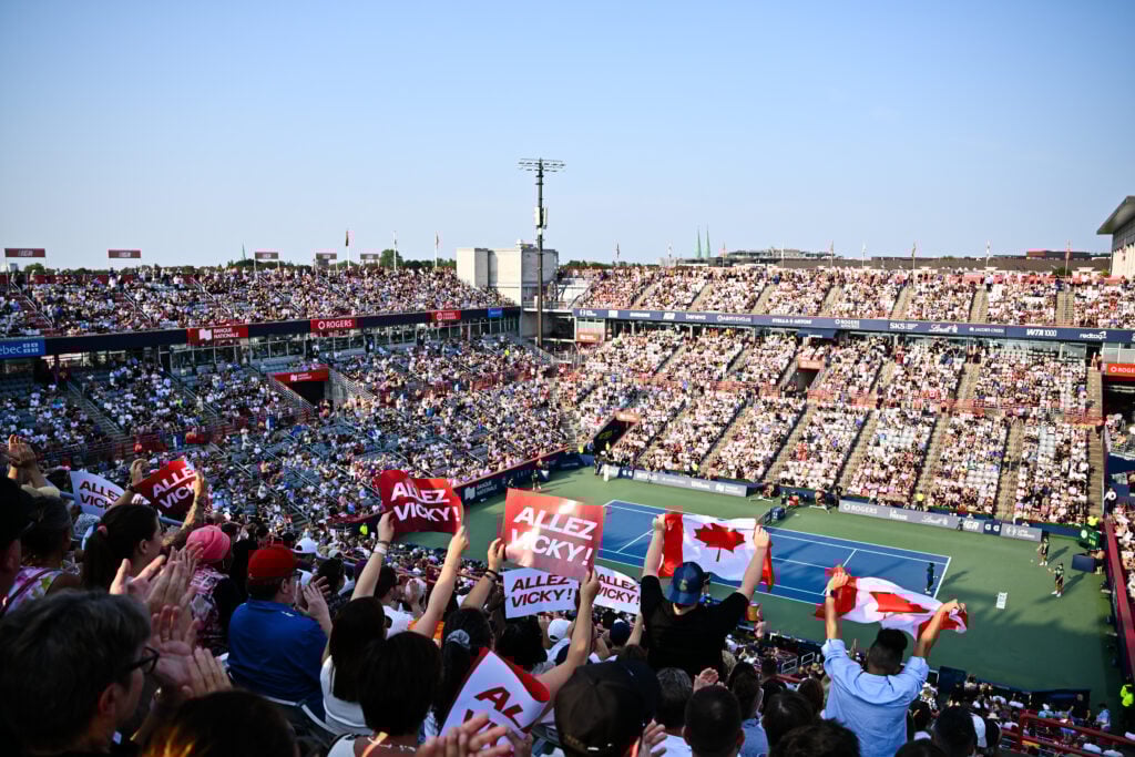 Fans in Montreal hold up signs to support Victoria Mboko in the Canadian Open final