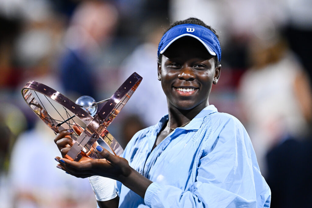 Victoria Mboko of Canada celebrates as she holds up the trophy following her victory against Naomi Osaka of Japan during the Women's Singles Final match on day twelve of the WTA 1000 National Bank Open at IGA Stadium on August 7, 2025 in Montreal, Quebec, Canada.