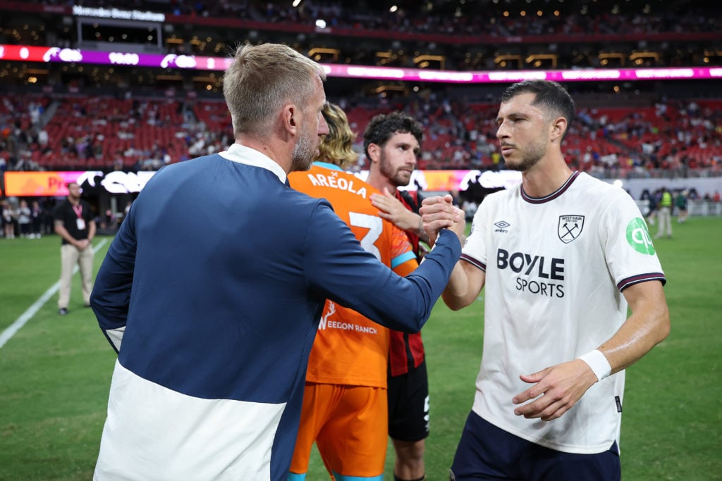 West Ham head coach Graham Potter shares a handshake with midfielder Guido Rodriguez