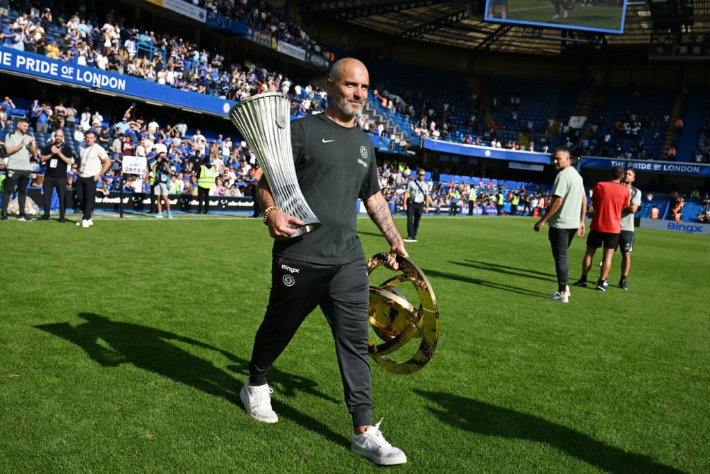 Enzo Maresca carries the Conference League and Club World Cup trophy after Chelsea v AC Milan - Pre-Season Friendly