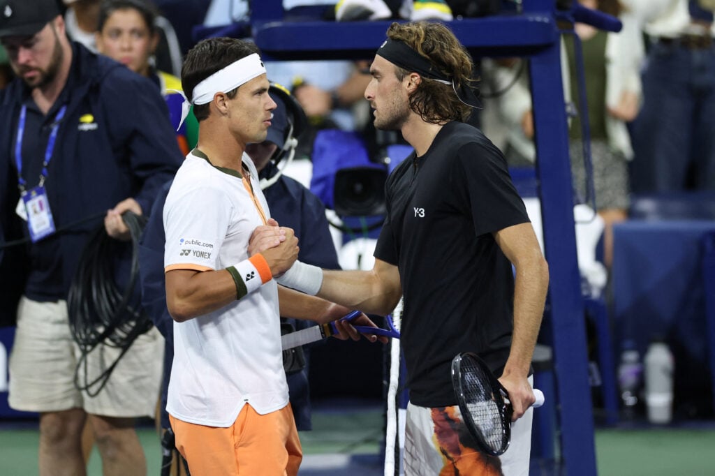 Daniel Altmaier and Stefanos Tsitsipas shake hands at the net after their match at the 2025 US Open