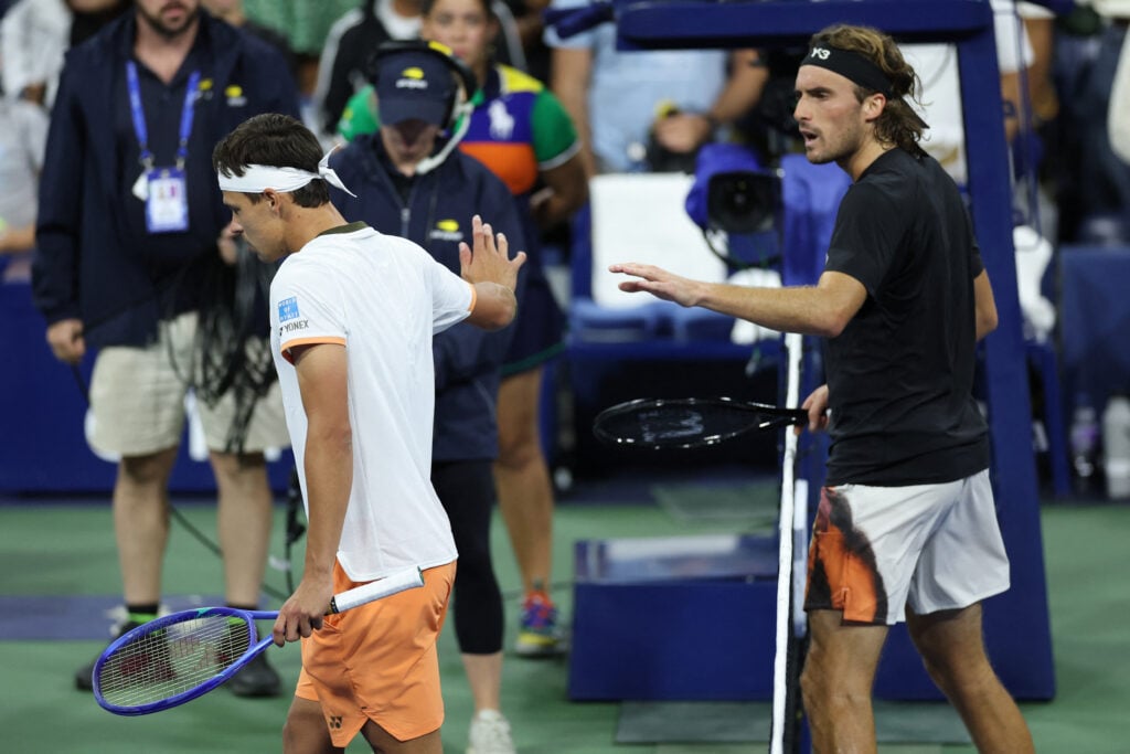 Stefanos Tsitsipas and Daniel Altmaier argue at the net at the 2025 US Open
