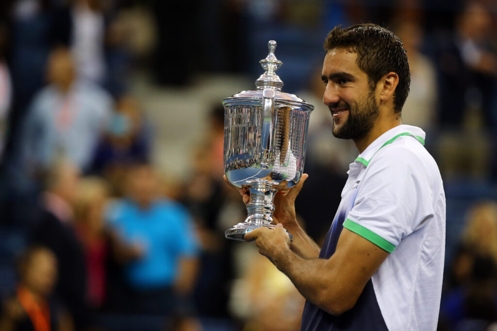 Marin Cilic of Croatia celebrates with the trophy after defeating Kei Nishikori of Japan to win the men's singles final match on Day fifteen of the 2014 US Open at the USTA Billie Jean King National Tennis Center on September 8, 2014 in the Flushing neighborhood of the Queens borough of New York City. Cilic defeated Nishikori by a score of 6-3, 6-3, 6-3.