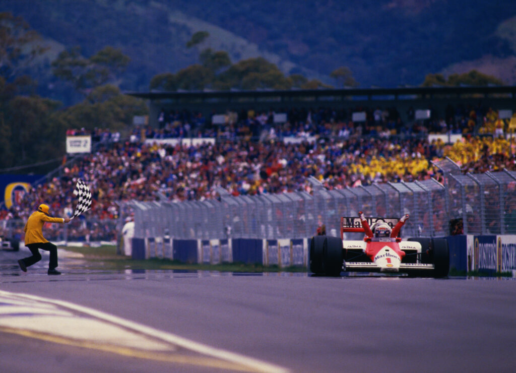 Alain Prost takes the chequered flag to win the Australian Grand Prix