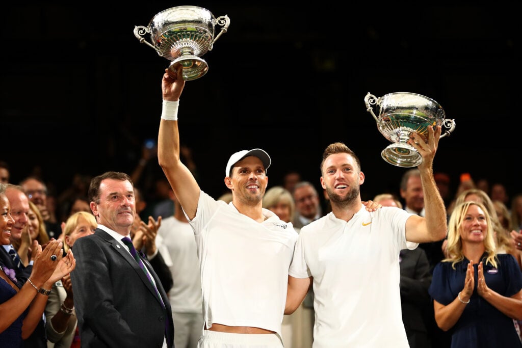 Mike Bryan and Jack Sock celebrate with their Wimbledon titles in 2018