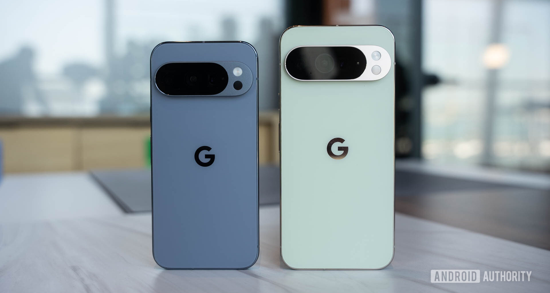 Google Pixel 10 Pro in Moonstone next to Google Pixel 10 Pro XL in Jade head on standing upright