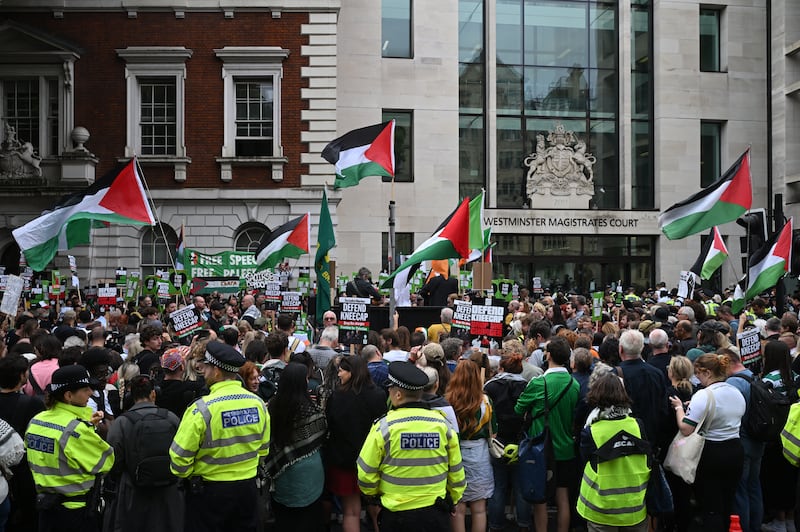 Supporters of Kneecap's Liam Og O hAnnaidh, spill onto the road outside Westminster Magistrates' Court, London, where he is appearing charged with a terrorism offence. The 27-year-old, who performs under the stage name Mo Chara, has been charged with a terrorism offence relating to displaying a flag in support of Hizbullah at a gig at the O2 Forum in Kentish Town, London, last November. Photograph: Justin Tallis/AFP via Getty Images)          