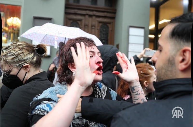 Kitty O'Brien interacts with a Berlin police officer after being punched in the face. Photograph: Irish Bloc Berlin