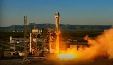 a white rocket lifts off from a desert launch site into the dawn sky