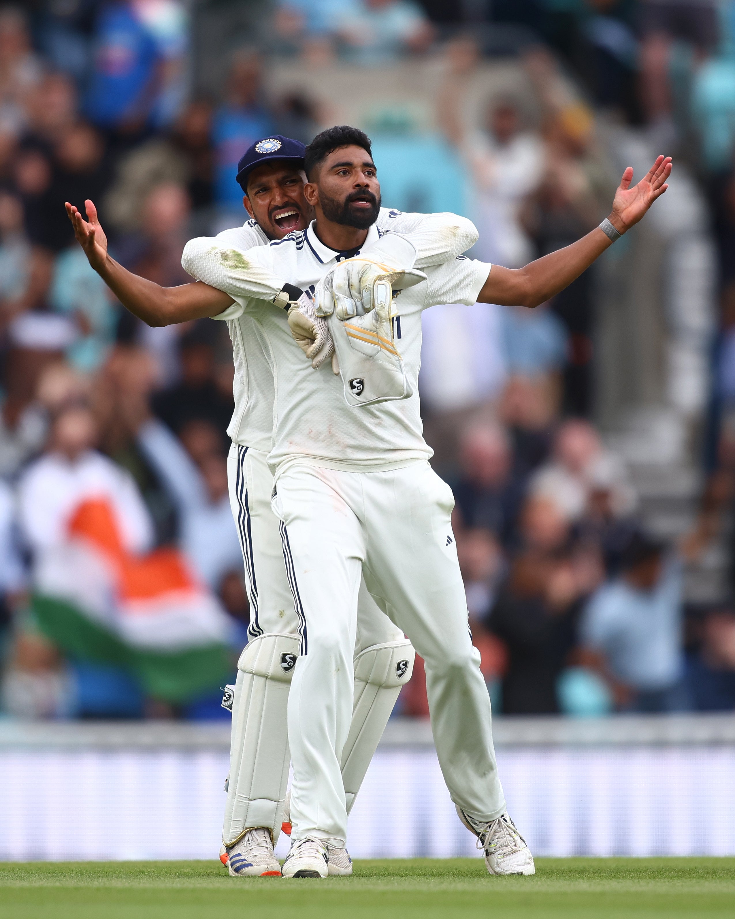 Mohammed Siraj of India celebrates with team mate Dhruv Jurel after taking the wicket of Gus Atkinson of England